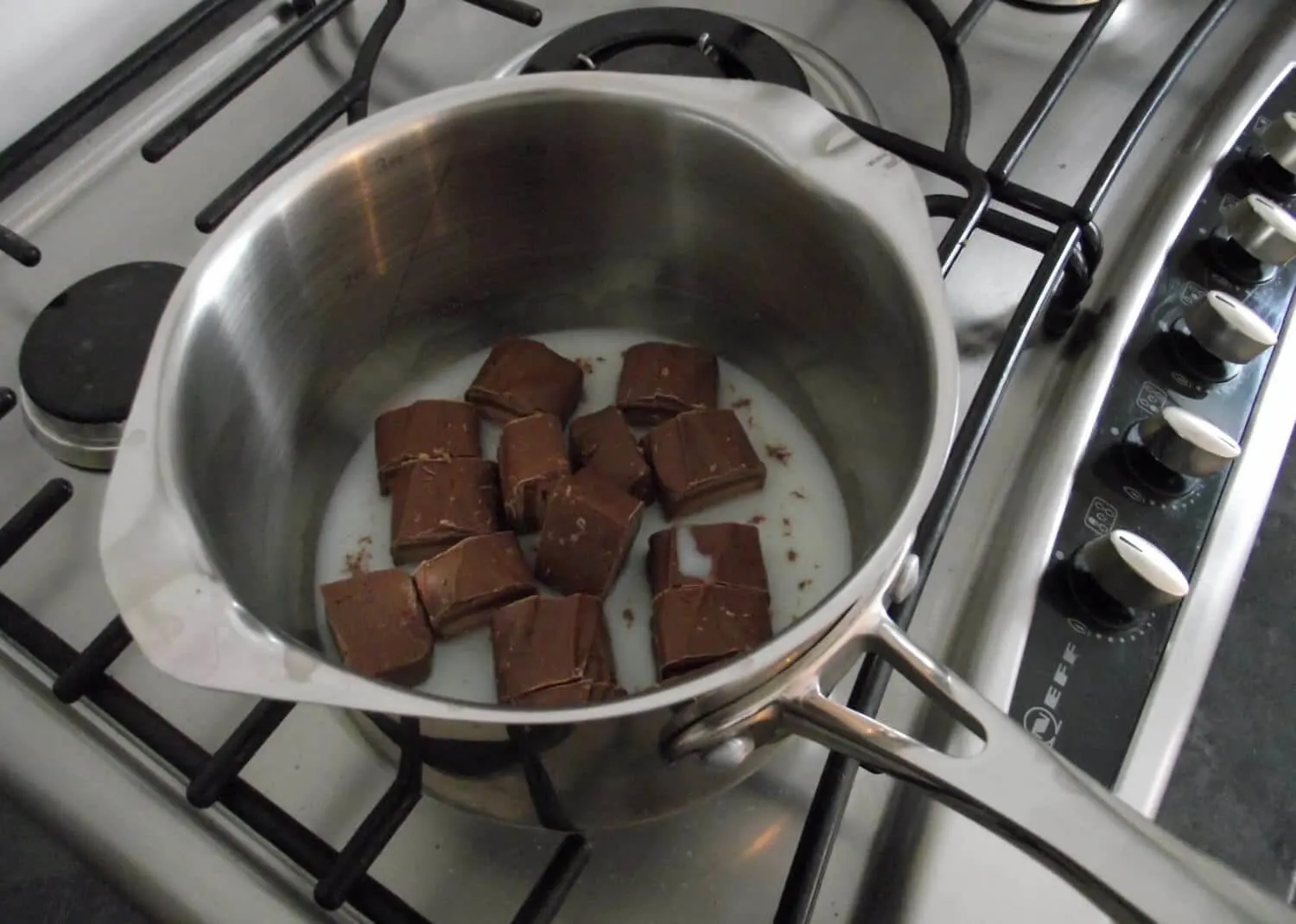 Mars Bars and milk in a saucepan on the hob