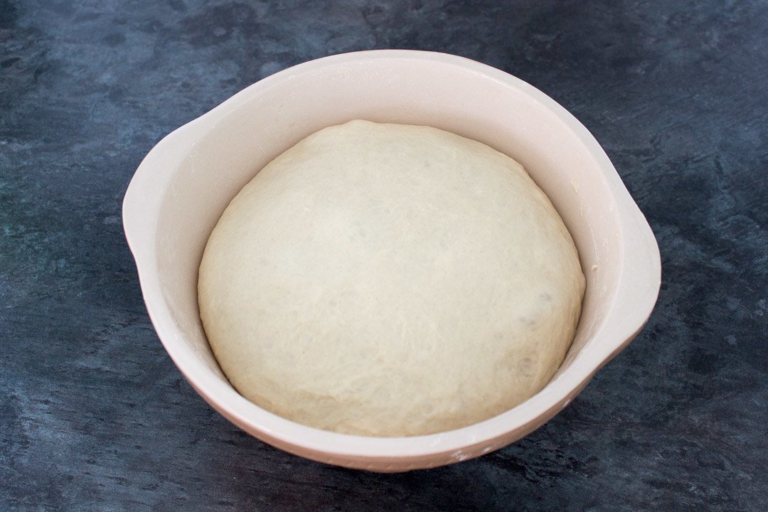 Risen no knead bread dough in a large mixing bowl after it's second prove