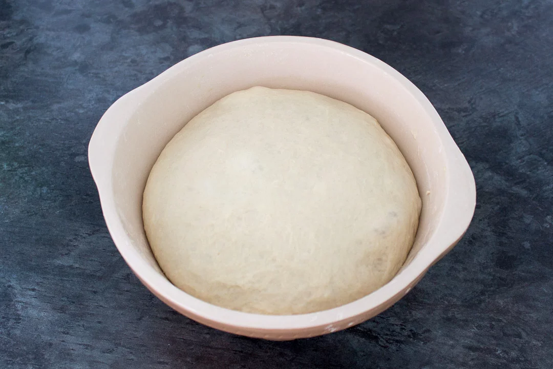 Risen no knead bread dough in a large mixing bowl after it's second prove