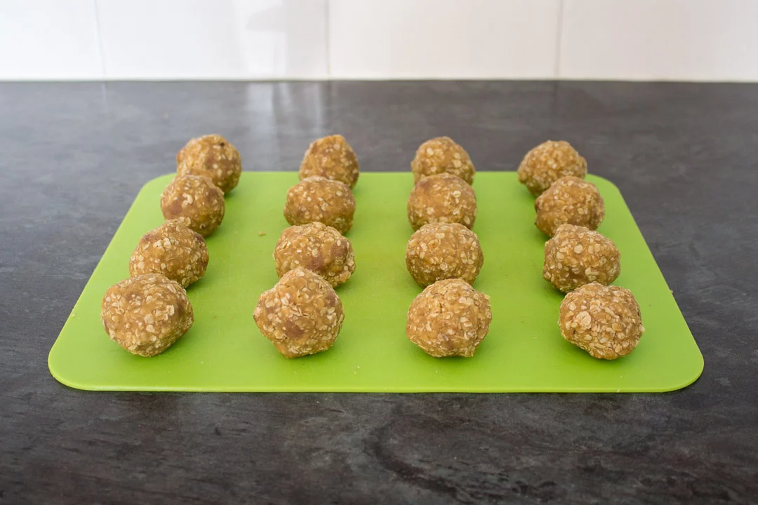 Chocolate hobnobs cookie dough balls on a chopping board