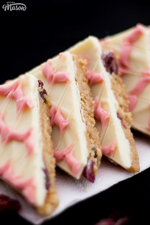 Cranberry white chocolate tiffin triangles in a line