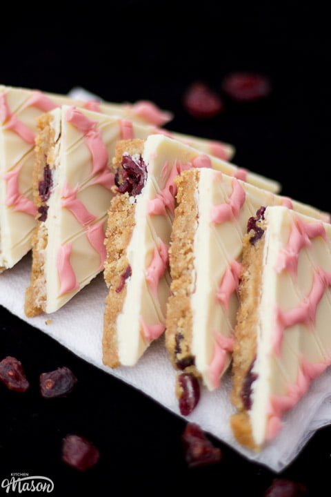 Cranberry white chocolate tiffin triangles in a line