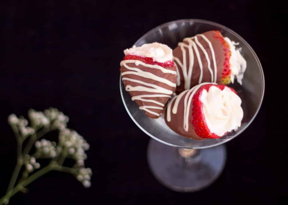 Cheesecake filled chocolate dipped strawberries in a Martini glass with gypsophila at the side
