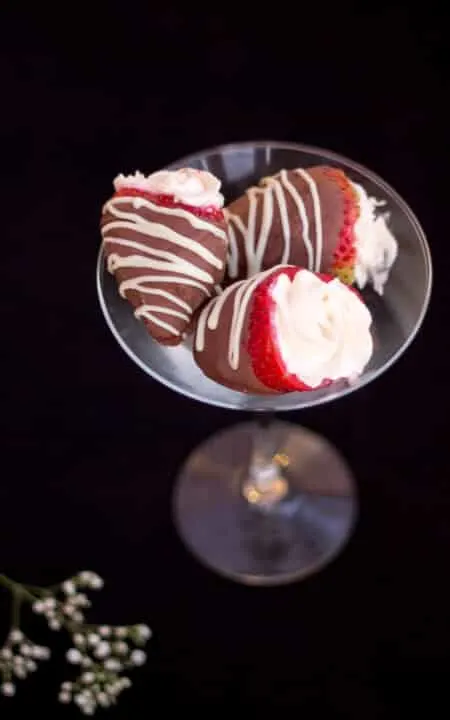 Cheesecake filled chocolate dipped strawberries in a martini glass