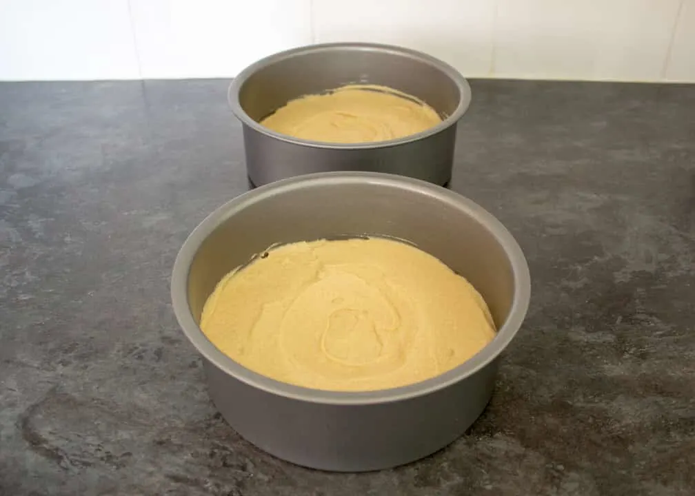 Victoria Sandwich Cake batter smoothed out in two round cake tins