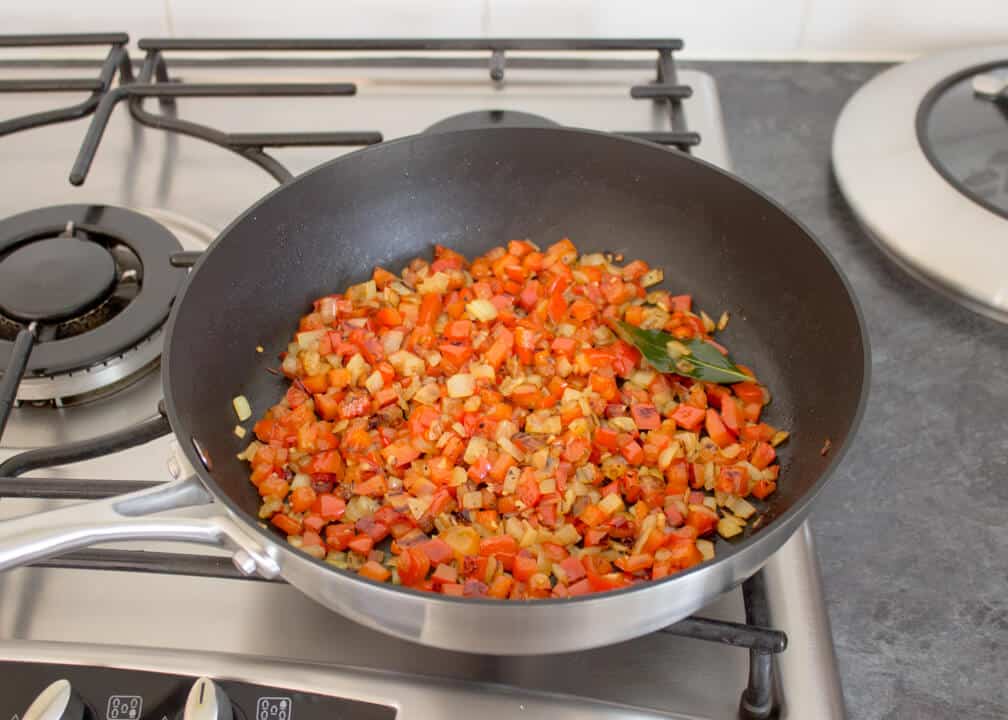 Golden onion, garlic, red pepper, chilli and bay leaves that's been fried in a pan