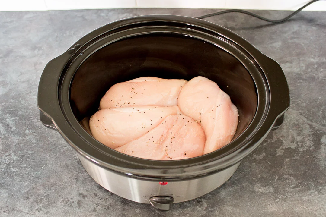 Seasoned chicken breasts in a slow cooker