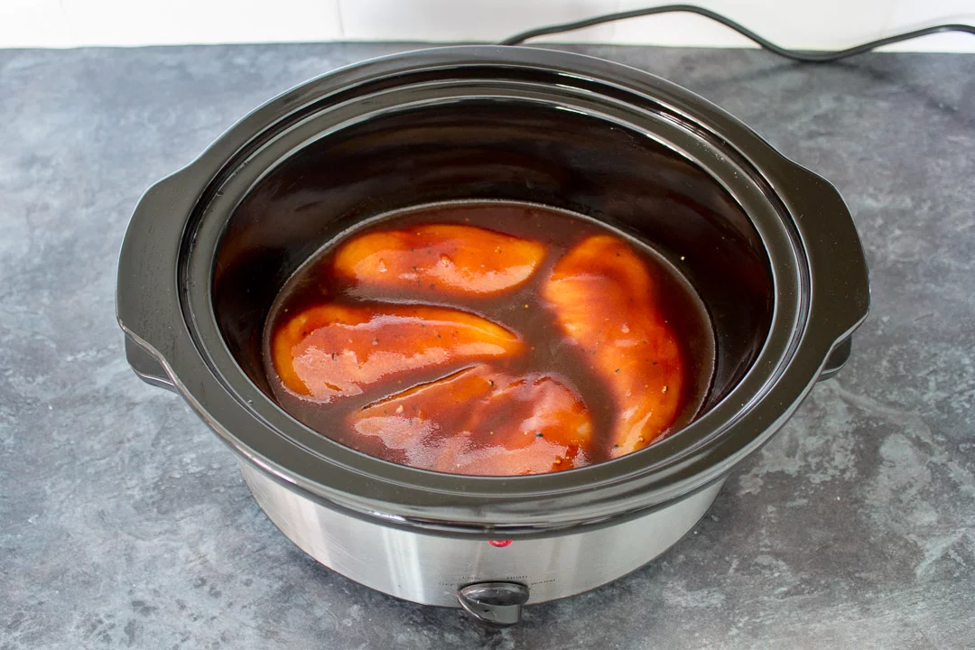 Slow cooker bbq chicken in a slow cooker, before being cooked