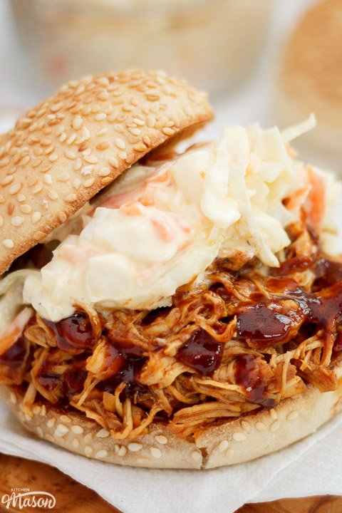 Slow cooker bbq chicken on a sesame seed bun with coleslaw