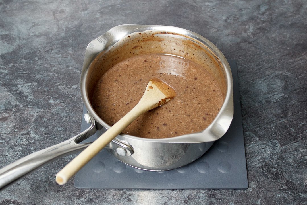 Butter, condensed milk and cocoa powder melted together in a small saucepan