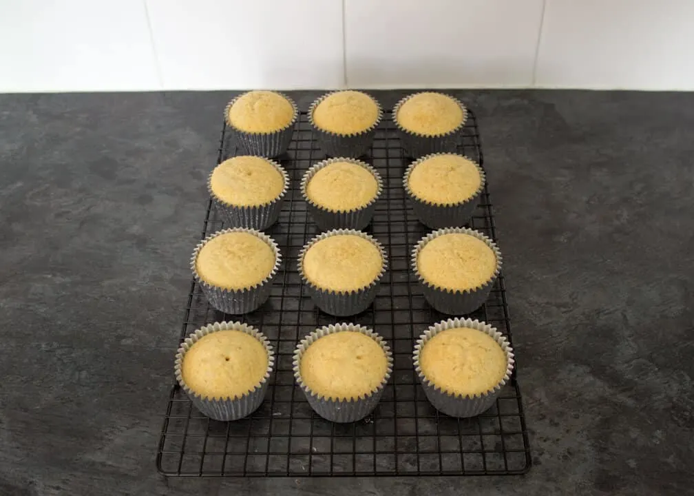 12 baked cupcakes on a cooling rack