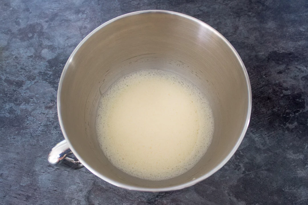 whipped egg whites in the bowl of an electric stand mixer