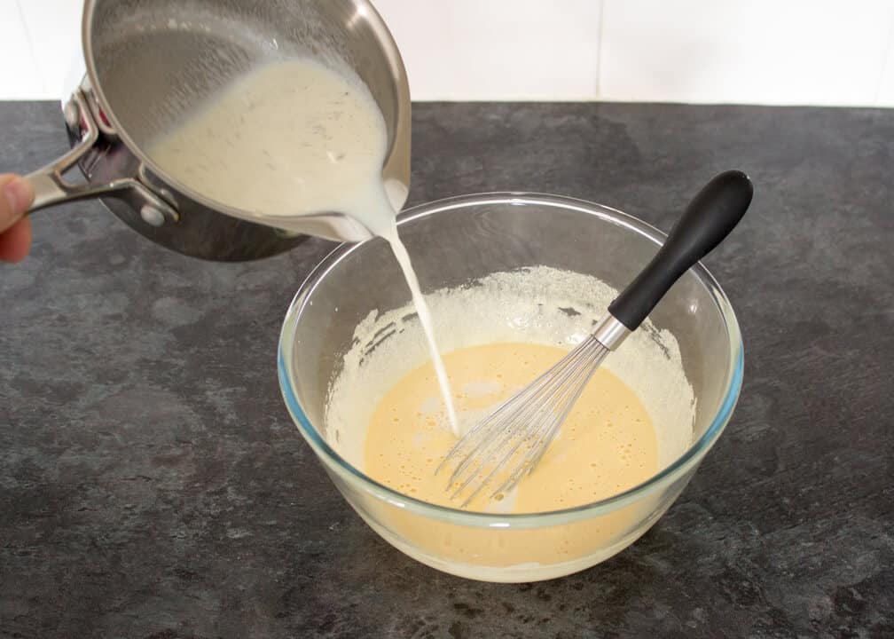 Rhubarb and Custard Ice Cream:custard mixture in a bowl/pouring milk in