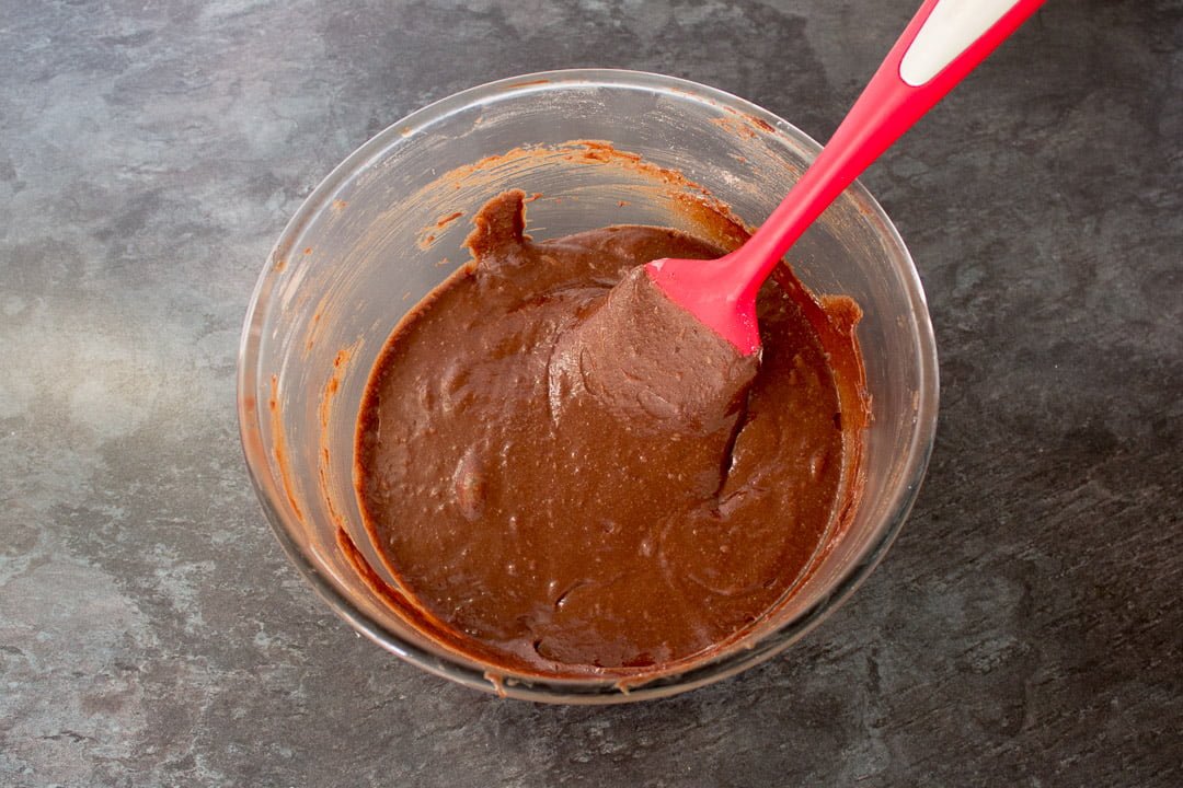 fudgy brownie batter in a glass bowl