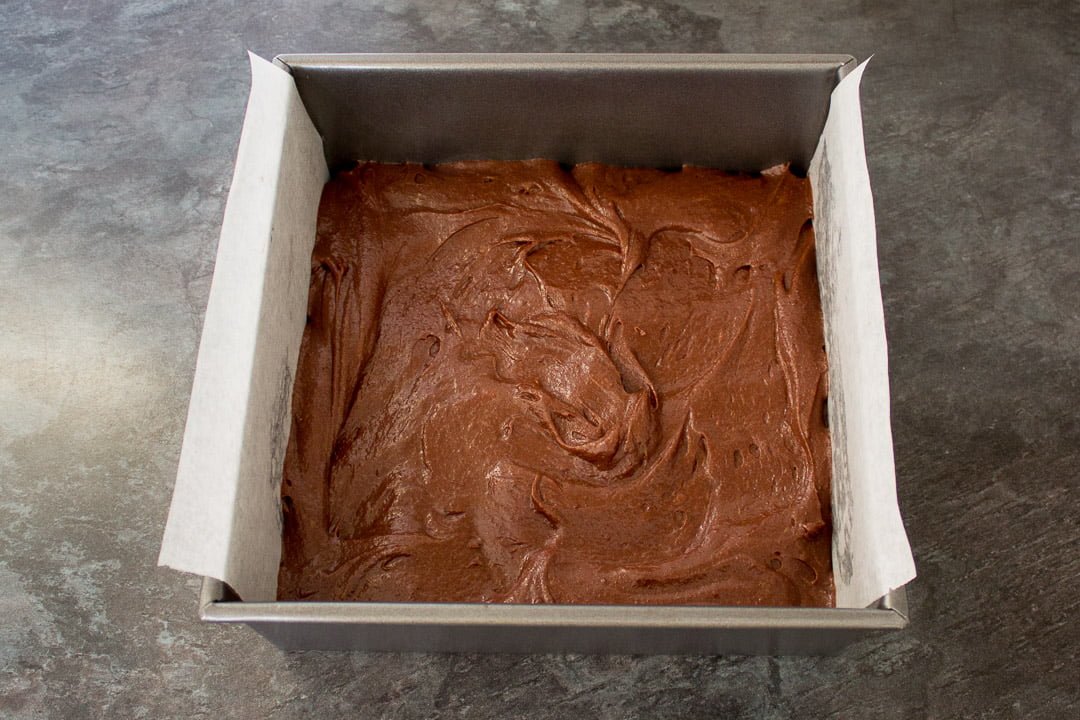 fudgy brownie batter in a baking tin, ready for the oven