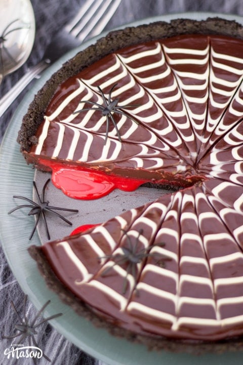 Halloween Dessert | No Bake Bloody Spider Web Chocolate Tart on a plate with plastic spiders