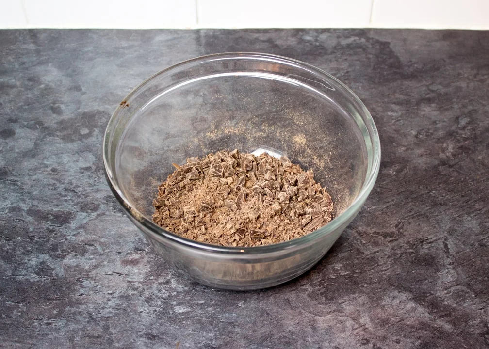 finely chopped dark chocolate in a glass bowl