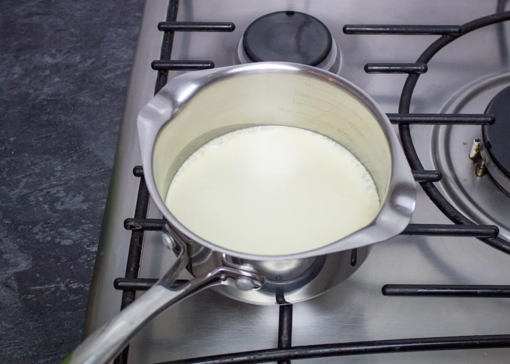 hot cream in a saucepan on the hob