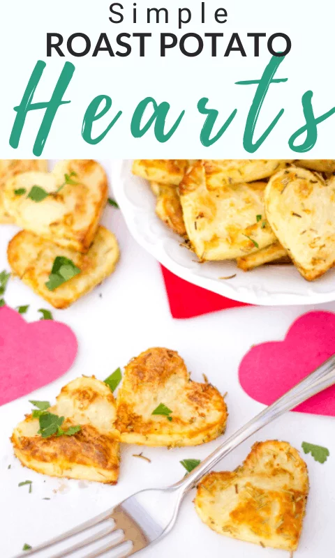 Roast potato hearts on a plate with a fork and pink paper hearts