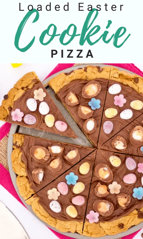 Easter chocolate cookie pizza sliced up on a pink piece of fabric