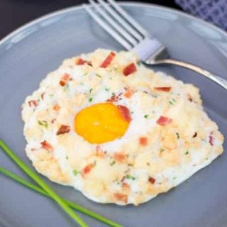 Bacon chive parmesan eggs in clouds on a plate with a fork