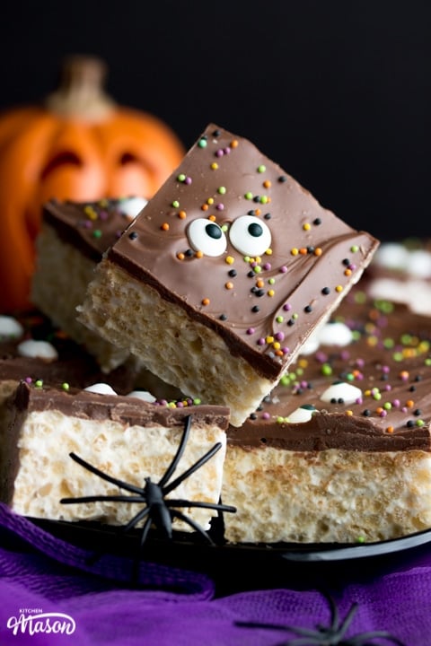 Rice Krispie Halloween treats on a plate with fake spiders
