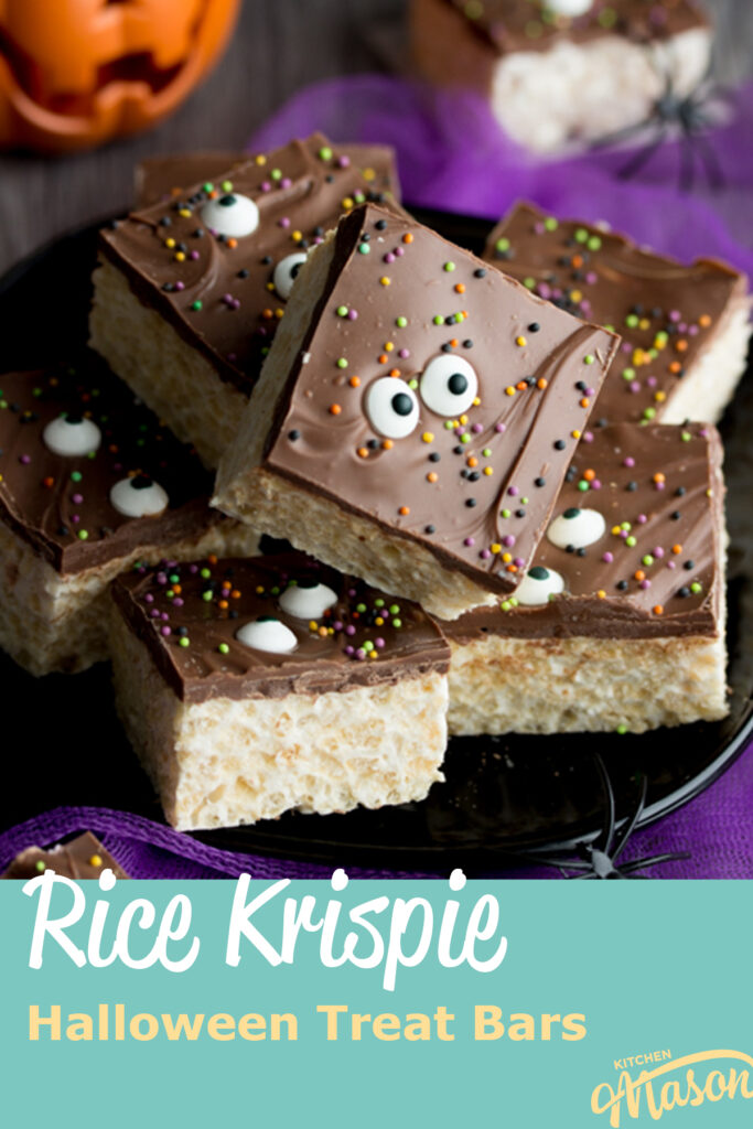 Rice Krispie Halloween treats on a black plate with fake spiders. Set against purple netting on a grey backdrop, there is also a small pumpkin light in the background. A text overlay says " rice krispie halloween treat bars"