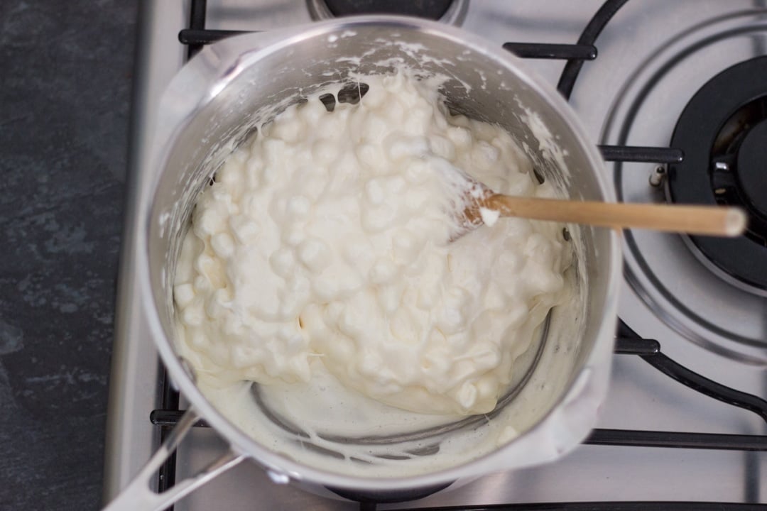 white mini marshmallows melting in a large saucepan