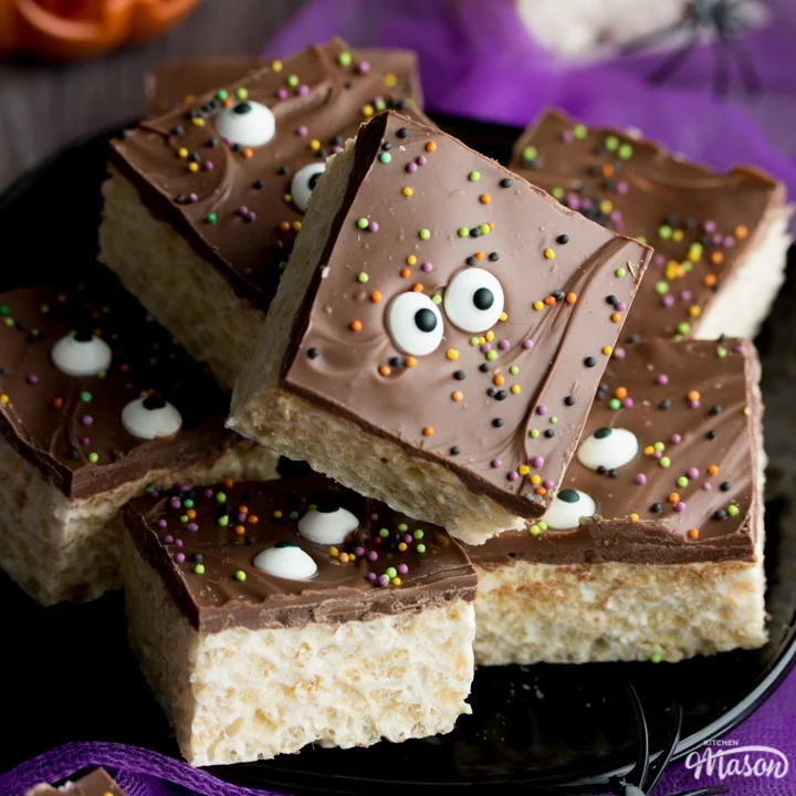 Rice Krispie Halloween treats on a plate with fake spiders