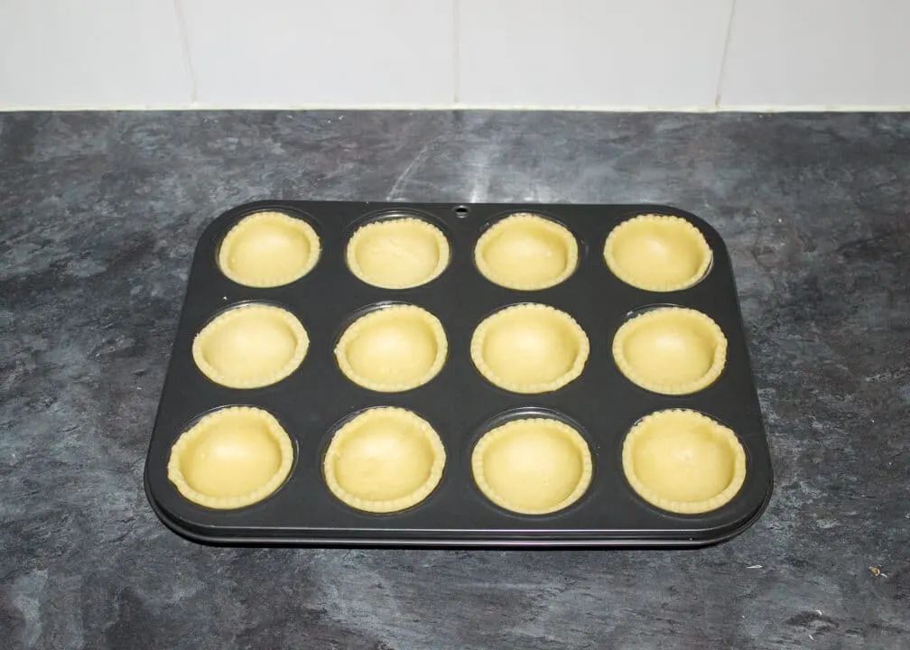 mince pies crusts lining a muffin tin