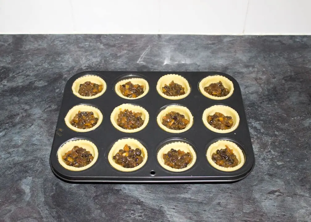 filled mince pies in a muffin tin