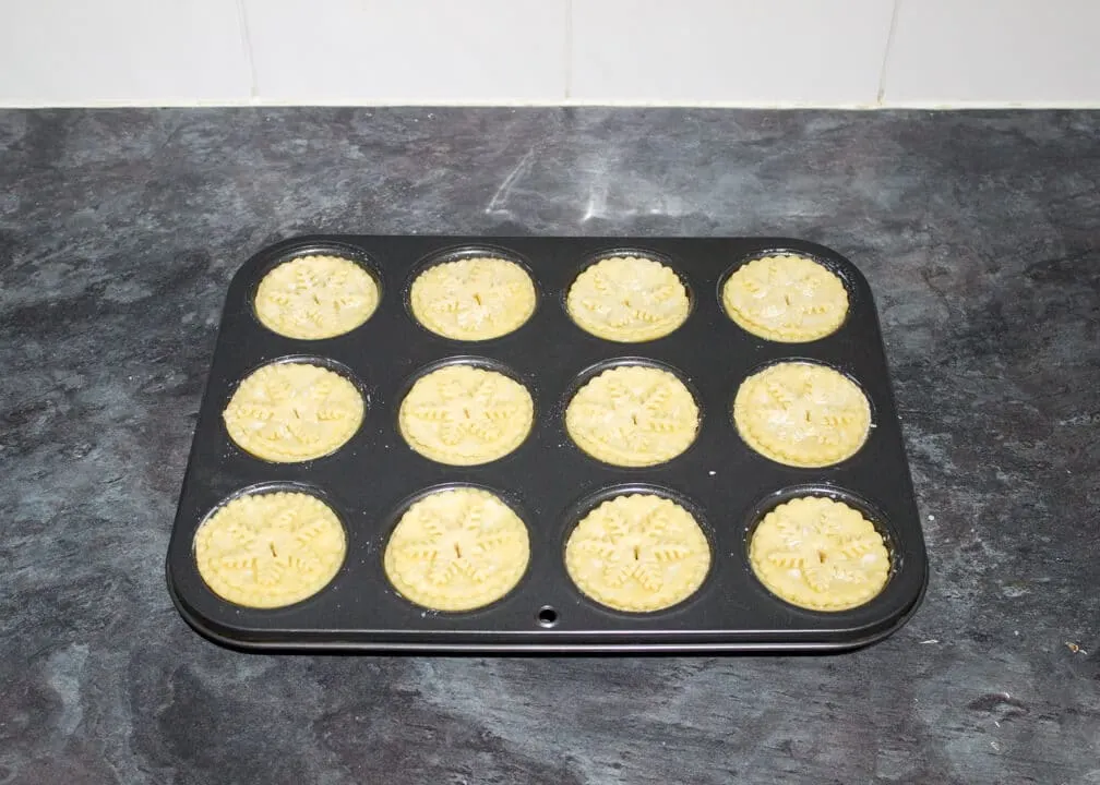 unbaked shortcrust pastry mince pies in a muffin tin
