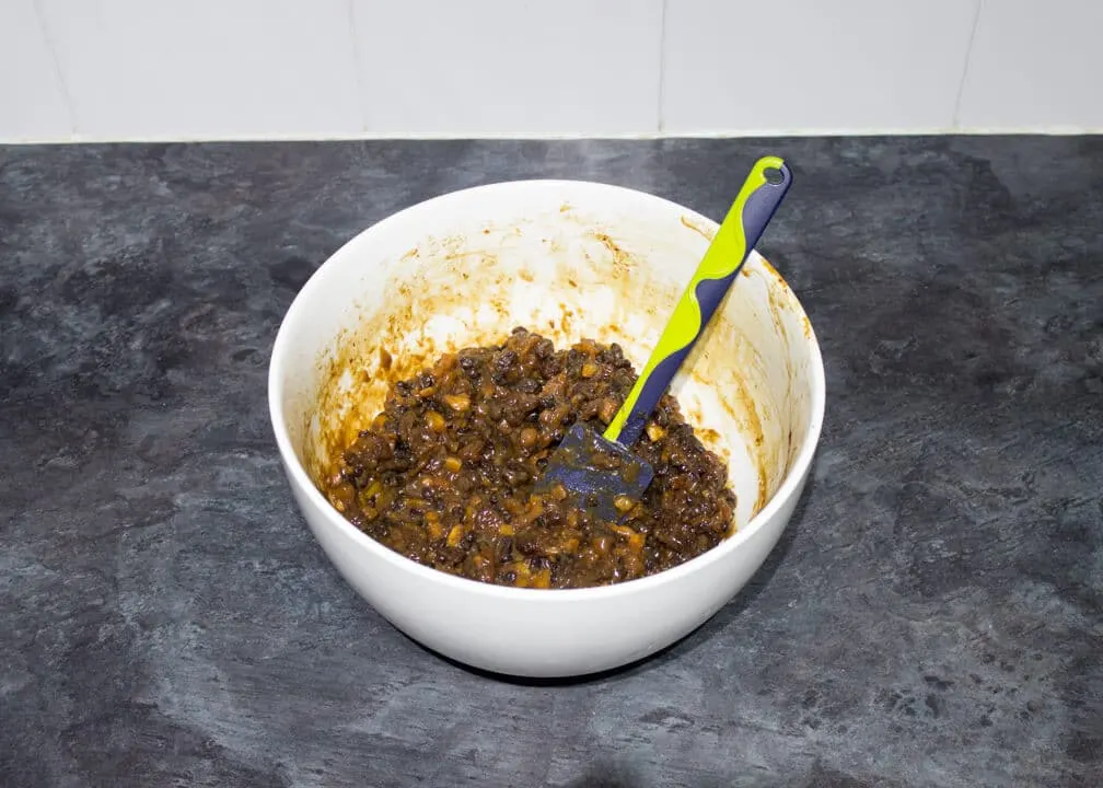 Cooked mincemeat in a large white bowl