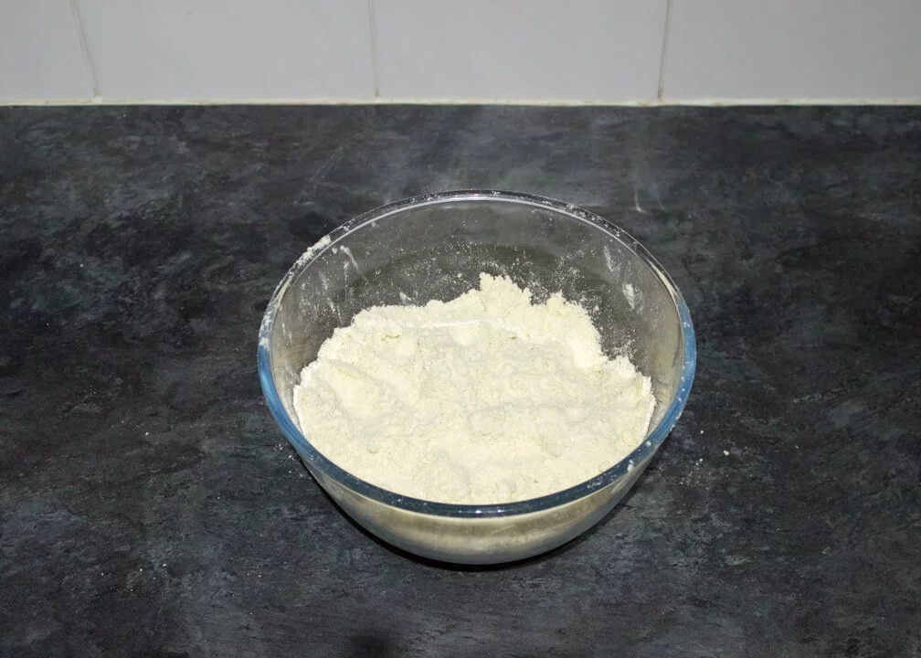 dry shortcrust pastry ingredients in a glass bowl