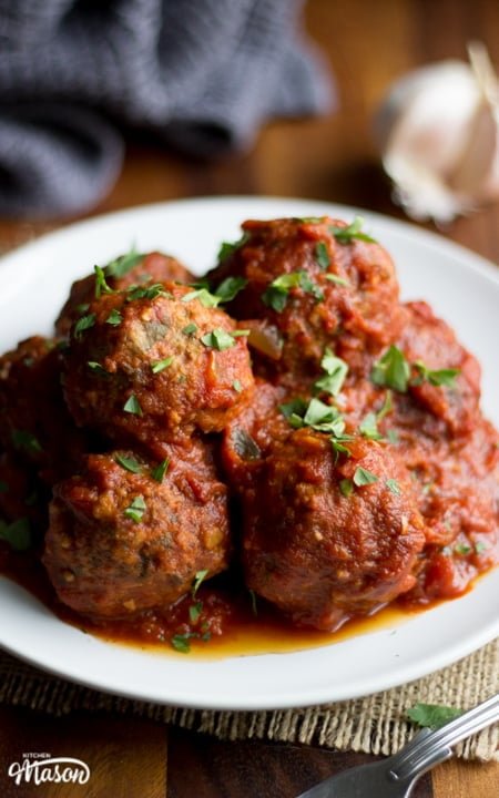 Slow Cooker Meatballs on a plate with parsley scattered on top
