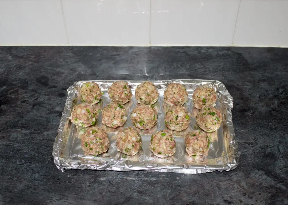 Turkey meatballs rolled into balls on a foil lined baking tray