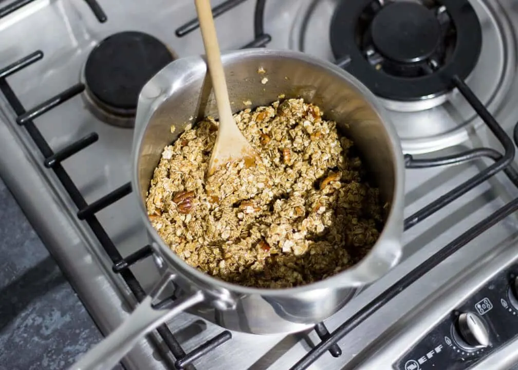 Flapjack Recipe: maple pecan flapjack mixture in a saucepan on the hob