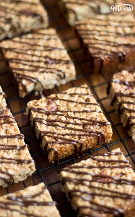 Flapjack Recipe: maple pecan flapjacks on a cooling rack drizzled in chocolate