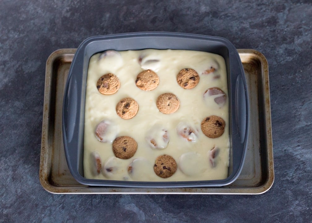 Milk & Cookies Chocolate Fudge Recipe: Melted Milk & Cookies Chocolate Fudge in prepared tin with cookies on top