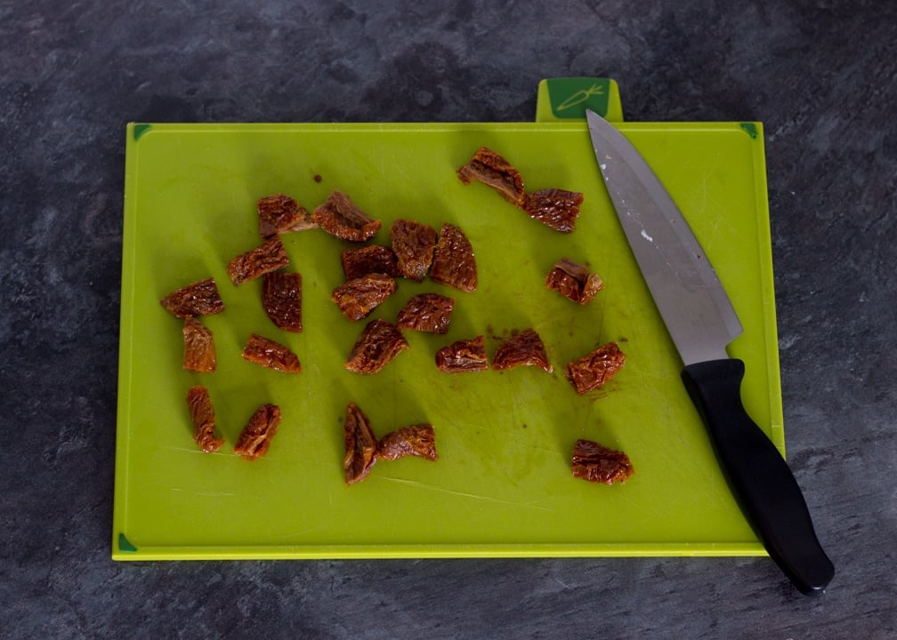 Party Snacks: Chopped sundried tomatoes on a chopping board