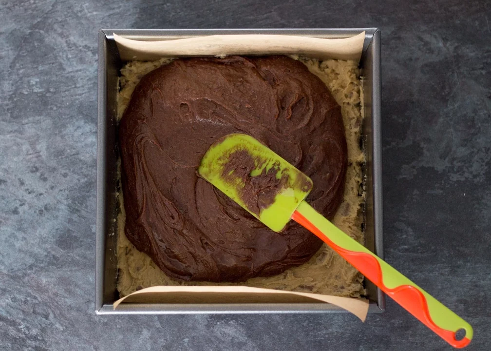 Brookie Recipe - Brownie batter on cookie dough in a baking tin