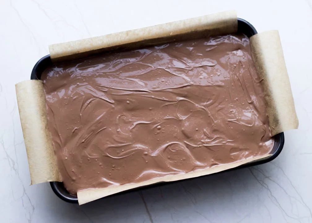 Chocolate Orange Caramel Shortbread: melted chocolate smoothed over the caramel layer in the baking tray