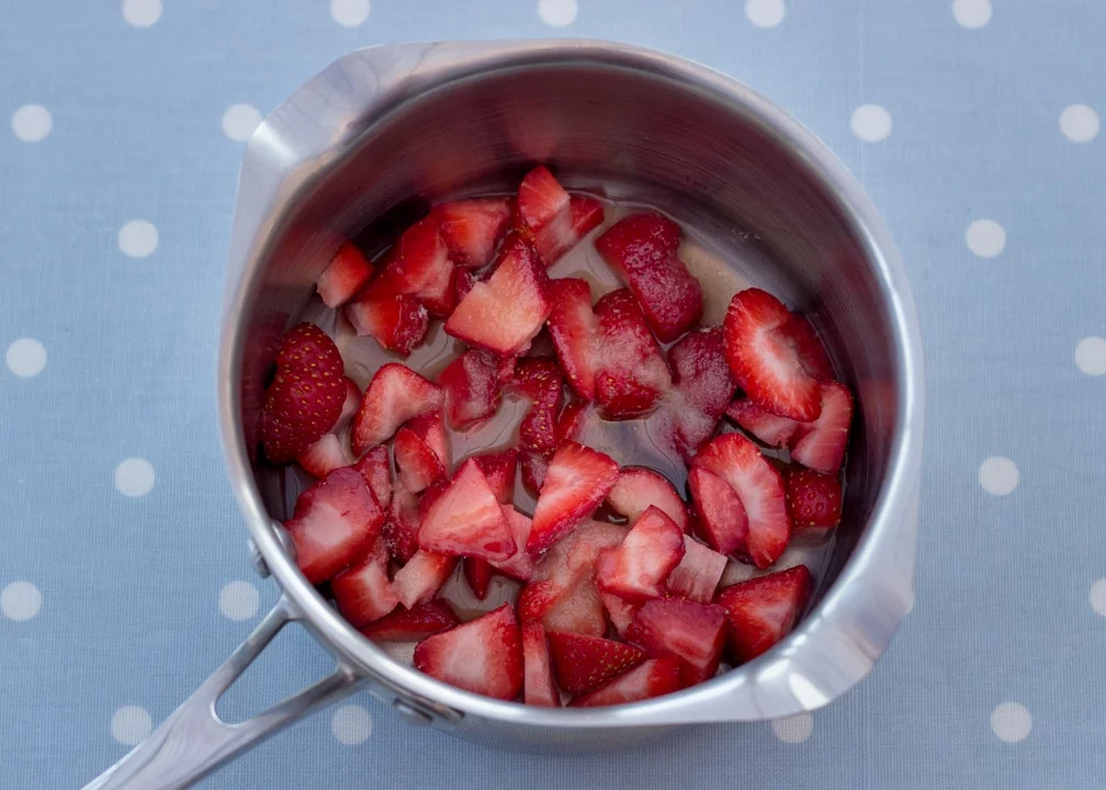 Vanilla Strawberry Cheesecake Recipe: Strawberry coulis ingredients in a pan uncooked