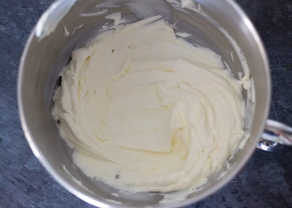Lemon Cheesecake Recipe: softened cream cheese in a stand mixer bowl