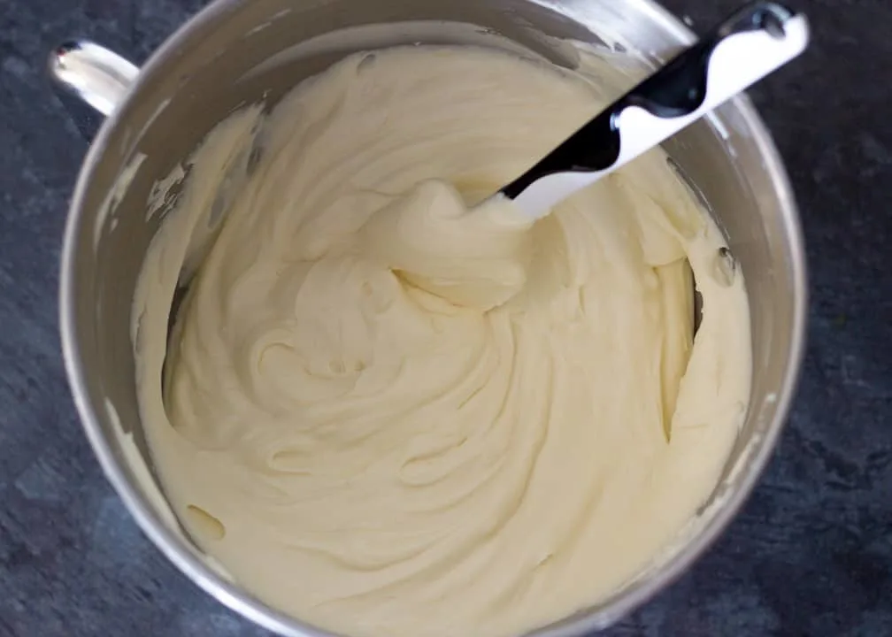 Lemon Cheesecake Recipe: beaten cream cheese, sugar and lemon curd in a stand mixer bowl with whipped double cream folded in