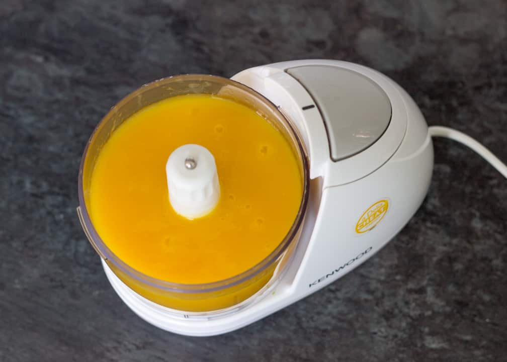 Homemade ice cream: mango puree in a mini food chopper
