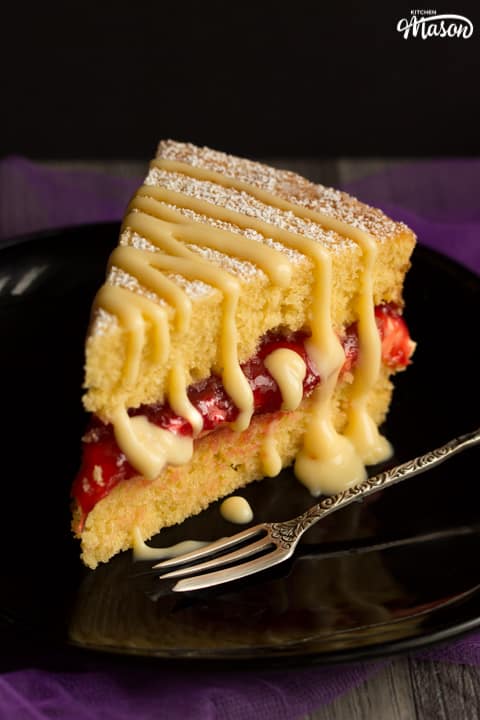 Slice of rhubarb and custard cake on a plate with a fork