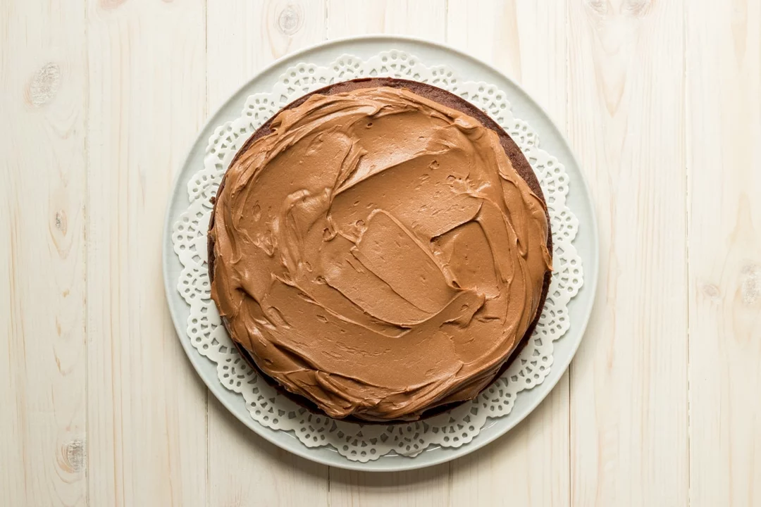 Easy chocolate cake recipe: One layer of chocolate cake on a plate topped with frosting