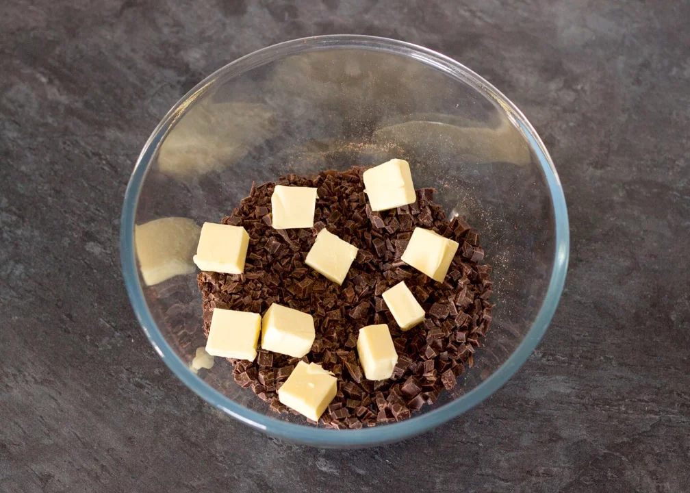 No Bake Caramel Chocolate Tart Recipe: butter and finely chopped chocolate in a glass bowl