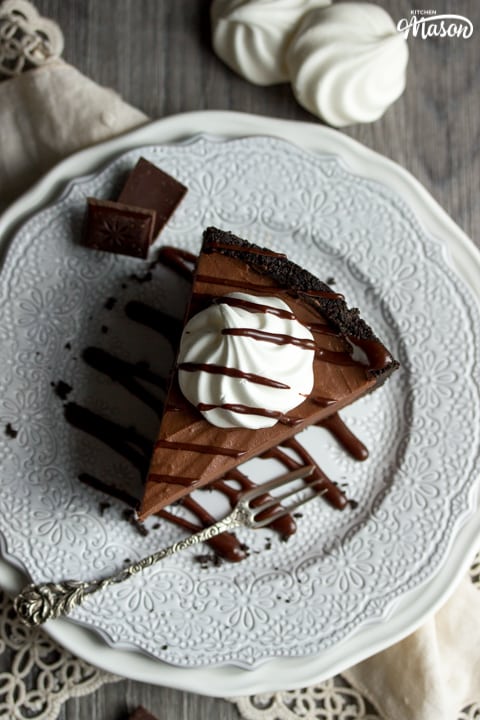 A slice of chocolate cheesecake on a plate with a fork